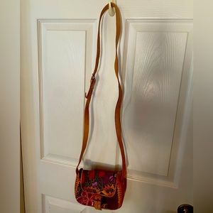 Leather and handcrafted fabric bag.